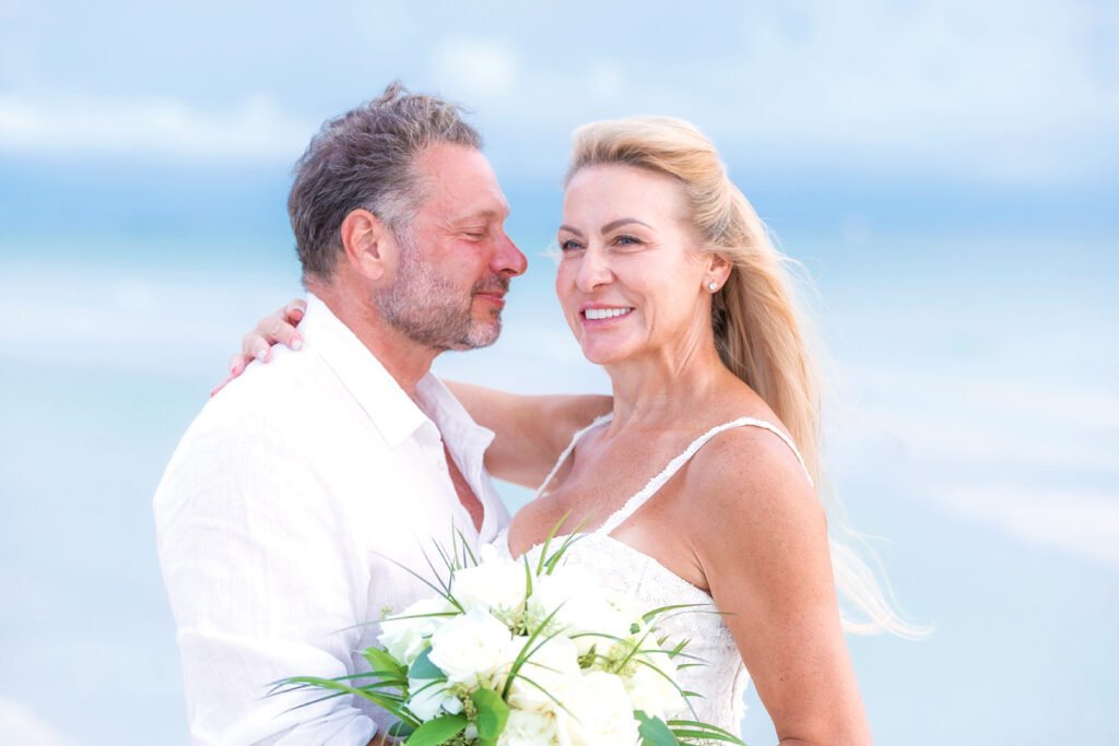 beach elopement couple hug after ceremony
